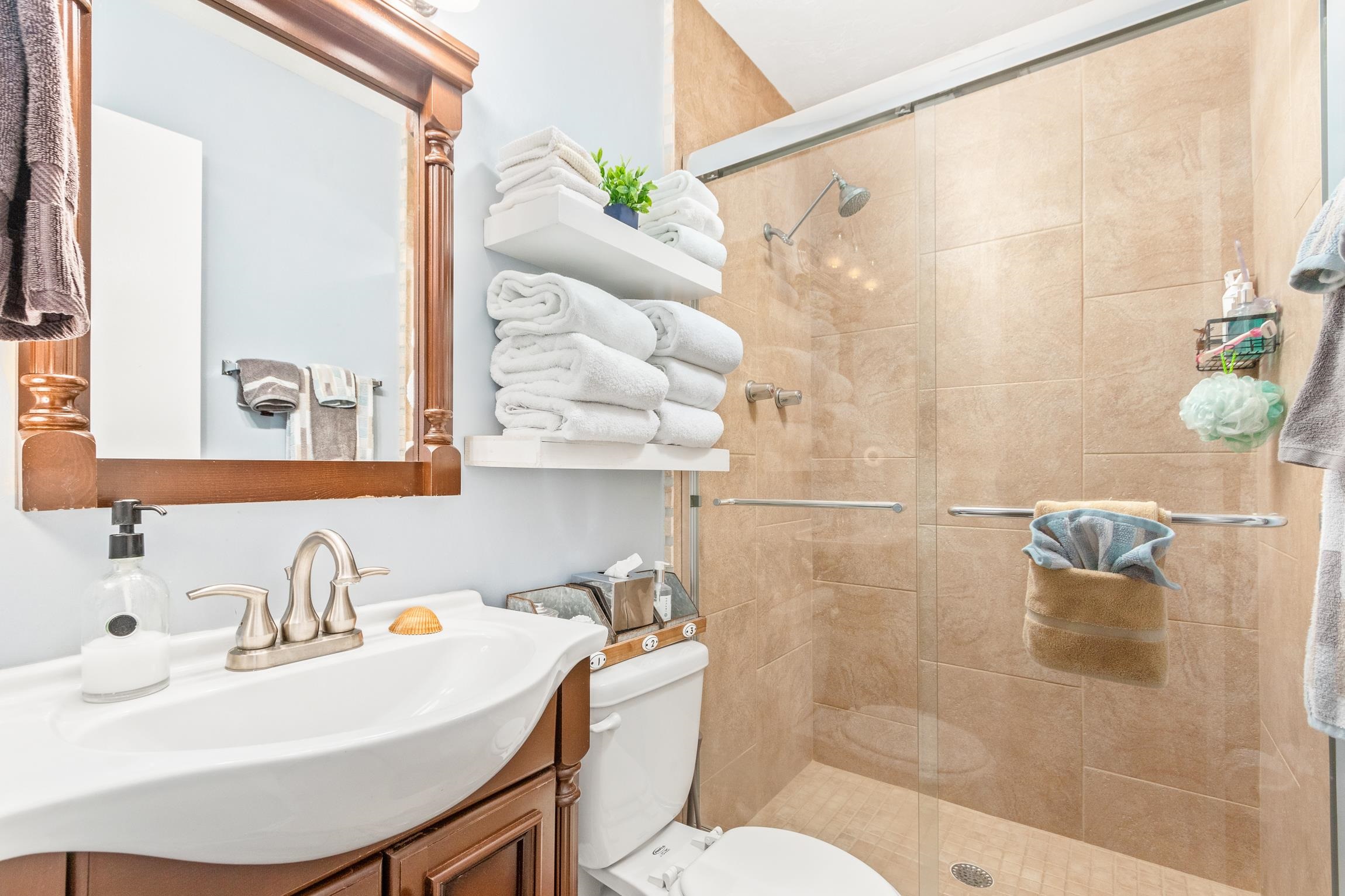 3385 Coastal Highway, Unit 22 St. Augustine, FL 32084 - Photo 16 of 35 a bathroom with a sink toilet and shower