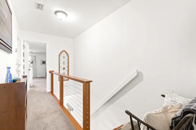 a large bed sitting in a bedroom next to a window