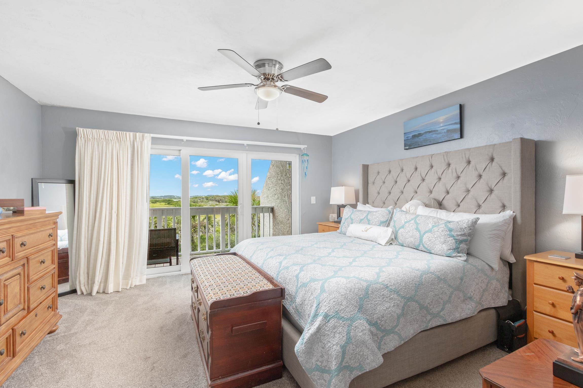3385 Coastal Highway, Unit 22 St. Augustine, FL 32084 - Photo 22 of 35 a bedroom with a large bed and a chandelier