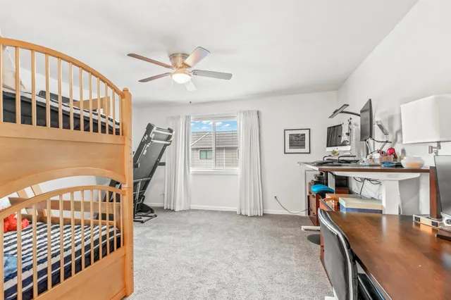 a bedroom with furniture and a ceiling fan