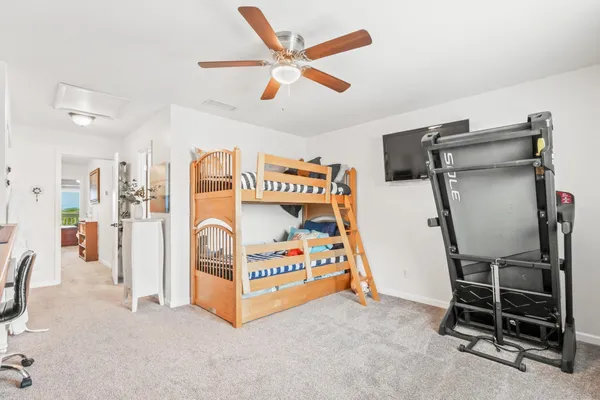 a large white kitchen with a sink a refrigerator and a stove top oven