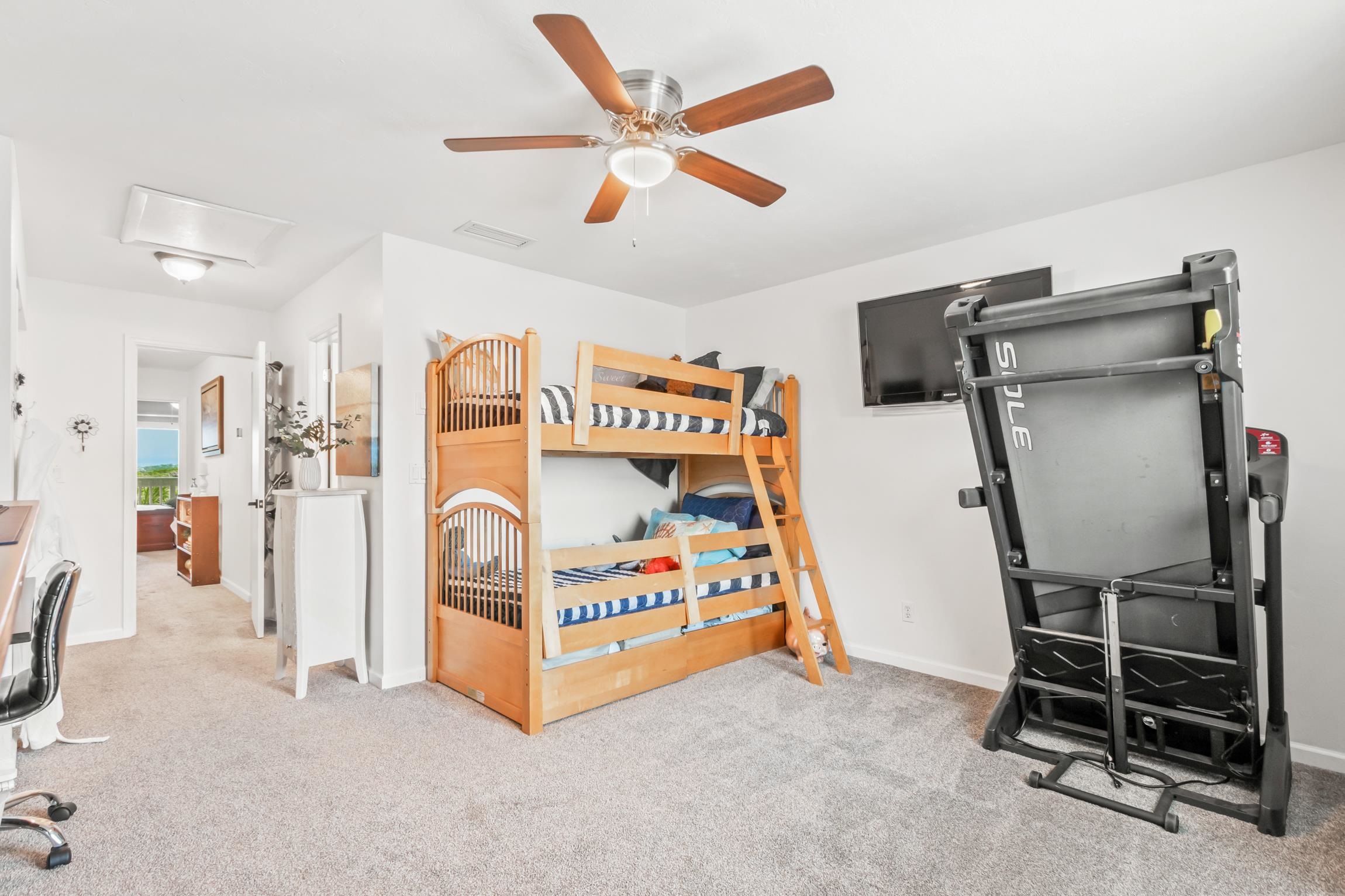 3385 Coastal Highway, Unit 22 St. Augustine, FL 32084 - Photo 30 of 35 a bedroom with furniture and a ceiling fan