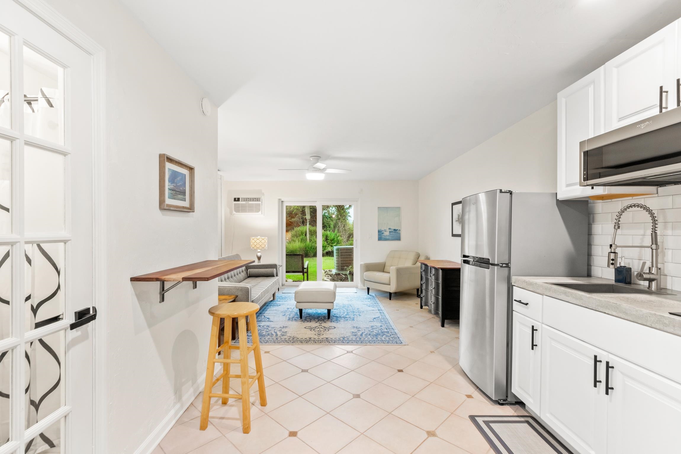 3385 Coastal Highway, Unit 22 St. Augustine, FL 32084 - Photo 31 of 35 a large white kitchen with a sink a refrigerator and a stove top oven
