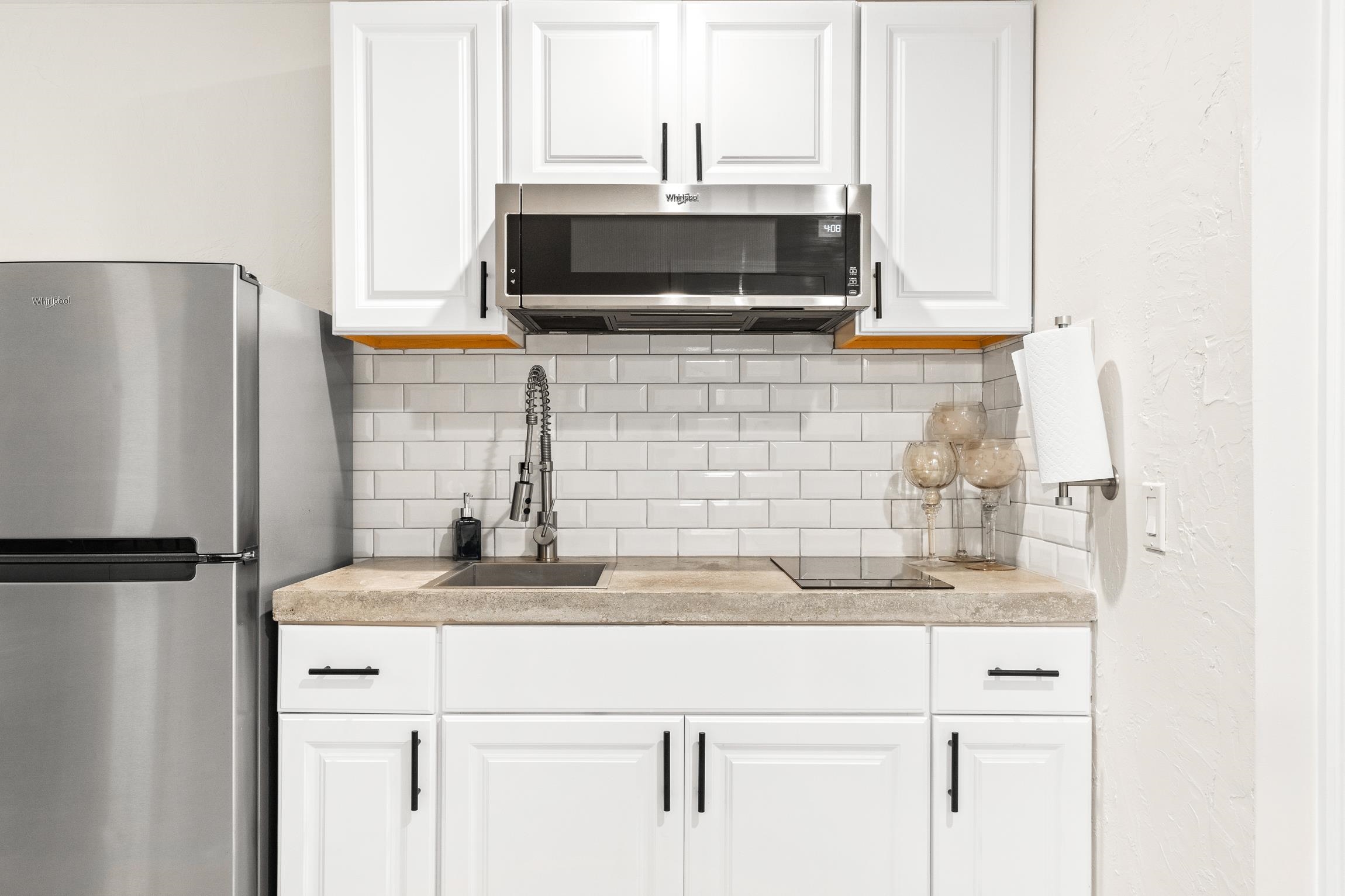 3385 Coastal Highway, Unit 22 St. Augustine, FL 32084 - Photo 32 of 35 a kitchen with stainless steel appliances a sink and a refrigerator