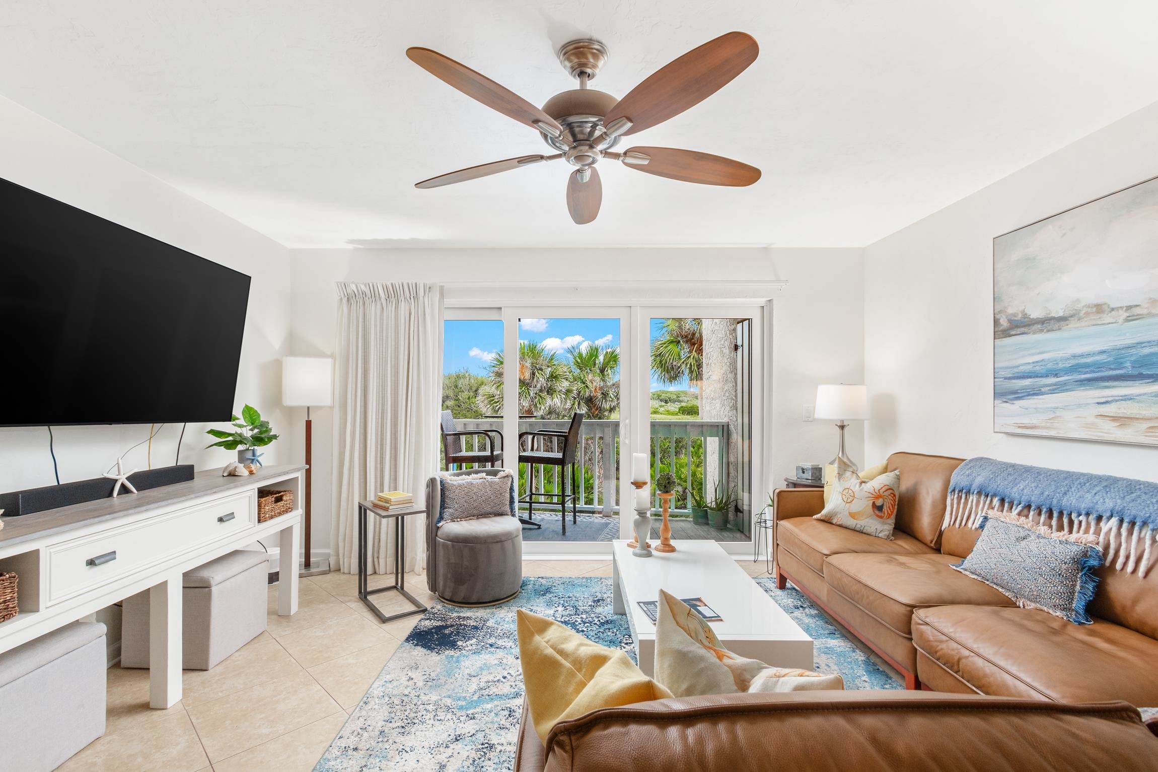 3385 Coastal Highway, Unit 22 St. Augustine, FL 32084 - Photo 7 of 35 a living room with furniture a flat screen tv and a large window