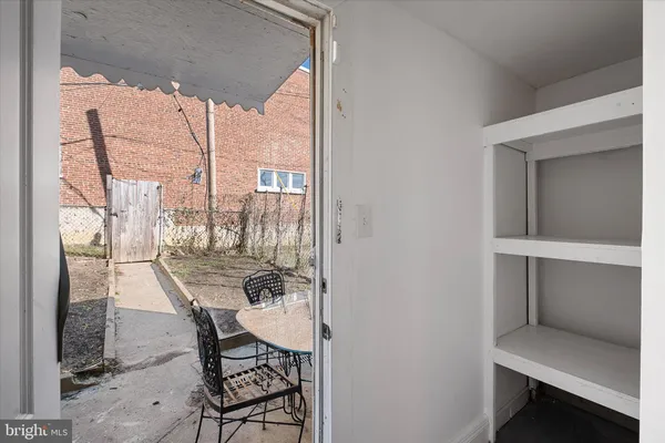 a dining room with furniture and a floor to ceiling window