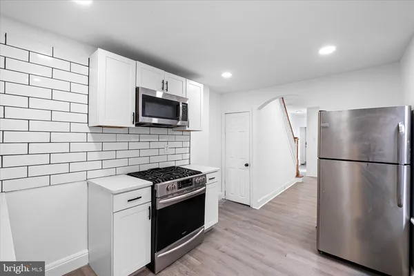 a kitchen with a refrigerator sink and stove