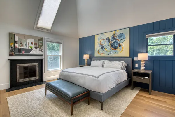 a bedroom with a bed and a fireplace