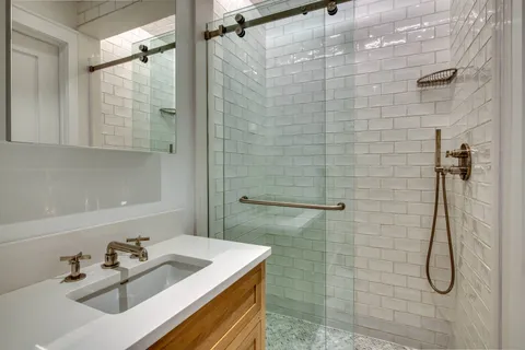 a bathroom with a sink shower and a bathtub