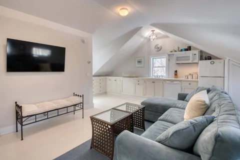 an aerial view of a house with a yard large tree and a yard