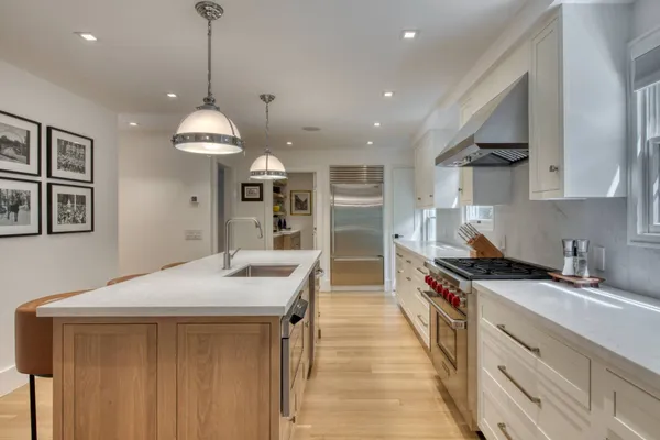 a open kitchen with stainless steel appliances granite countertop a sink a stove and a refrigerator