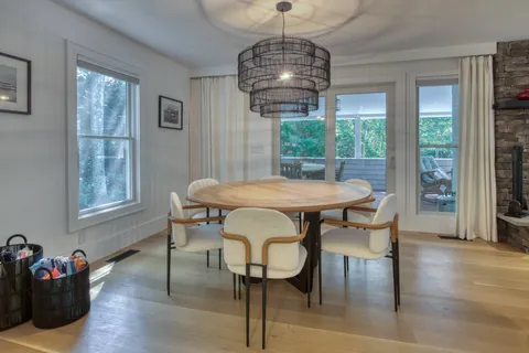 a view of a dining room with furniture window and wooden floor
