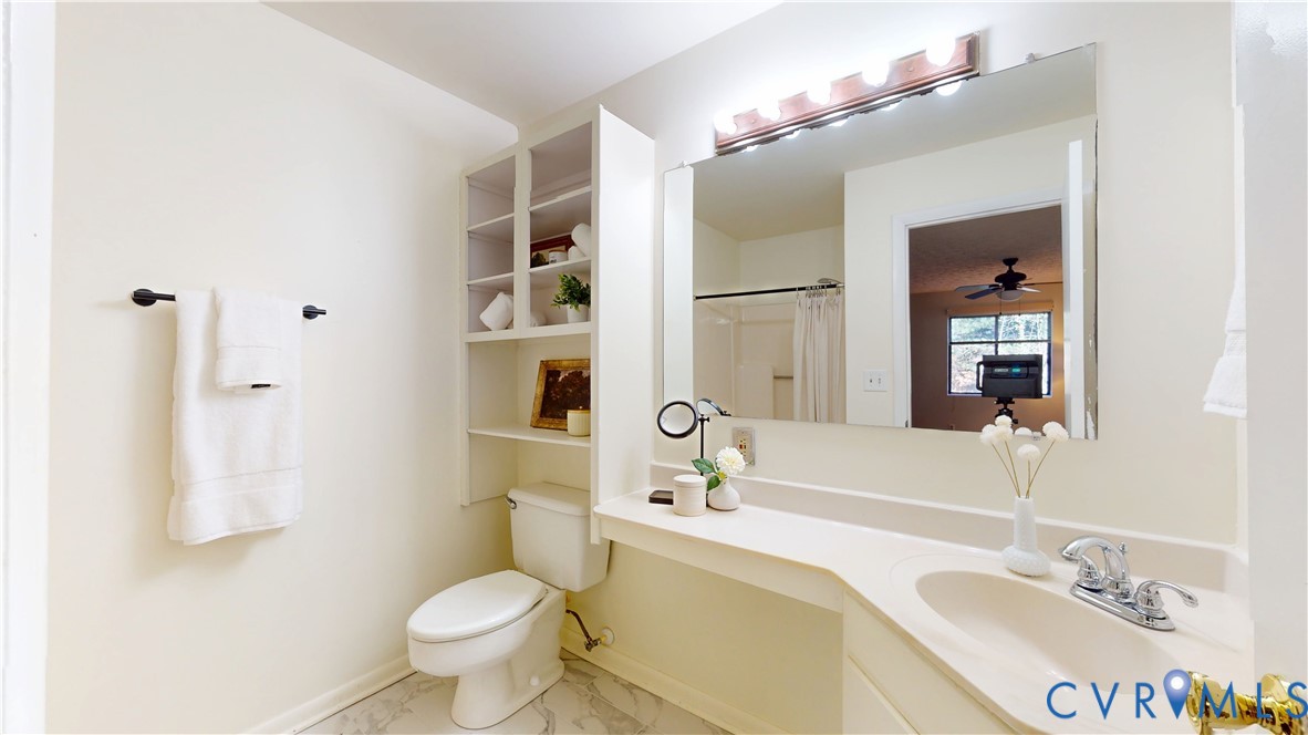 2106 Turtle Run Drive, Unit 7 Henrico, VA 23233 - Photo 15 of 22 a bathroom with a granite countertop sink a toilet a mirror and shower