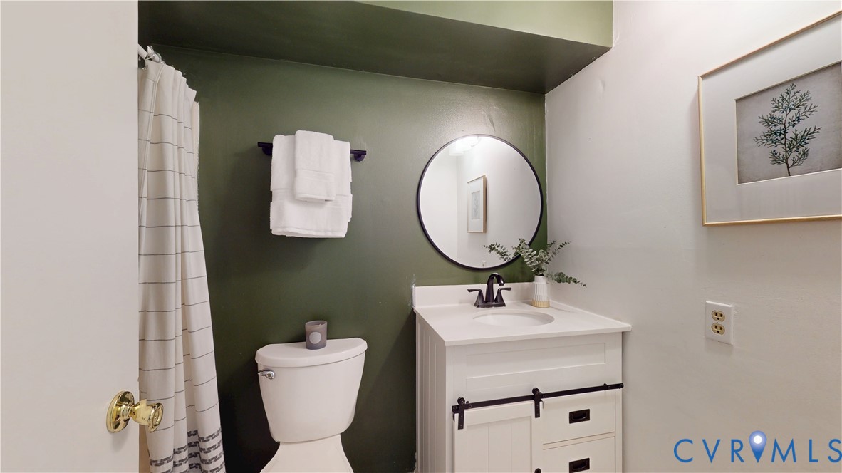 2106 Turtle Run Drive, Unit 7 Henrico, VA 23233 - Photo 19 of 22 a bathroom with a toilet sink and mirror