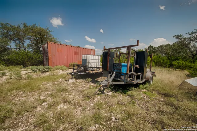 a view of a backyard with plants and a patio