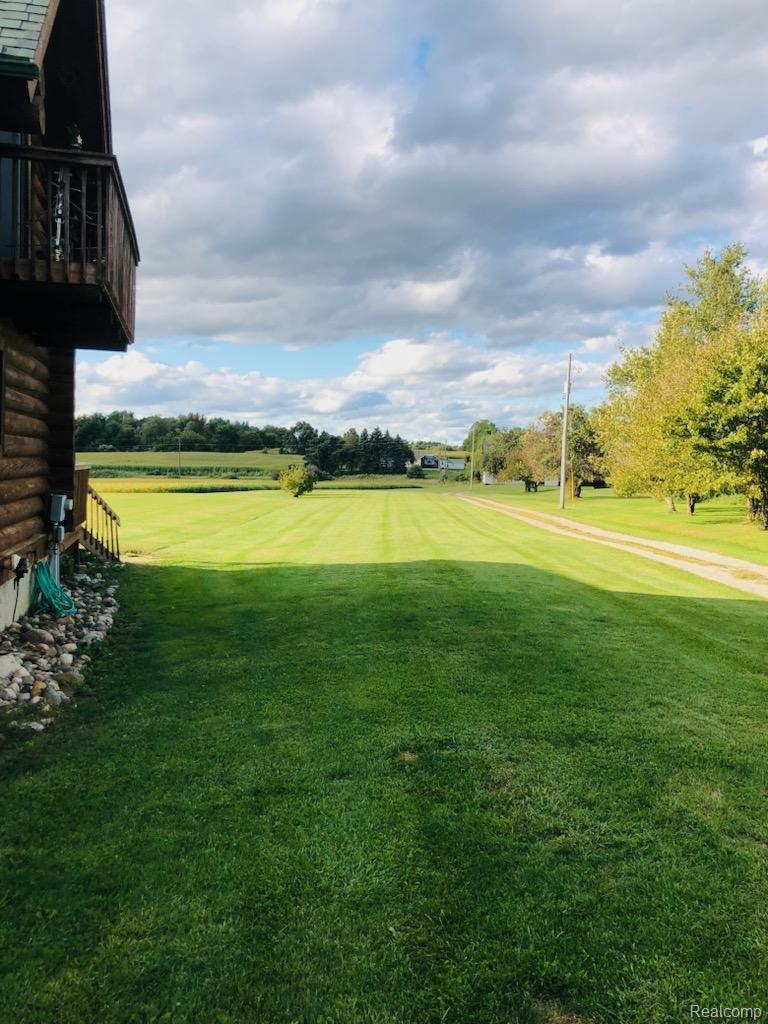 10374 Wilson Road Otisville, MI 48463 - Photo 18 of 99 View of grassy yard with view of wooded area and view of golf course