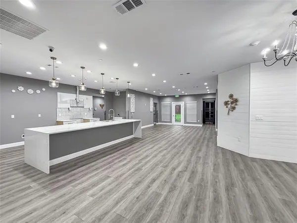 a large white kitchen with a white countertops and cabinets