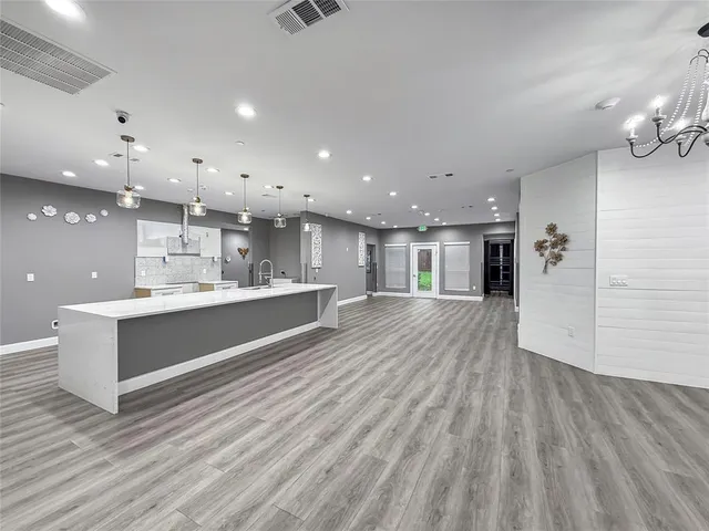 a large white kitchen with a white countertops and cabinets