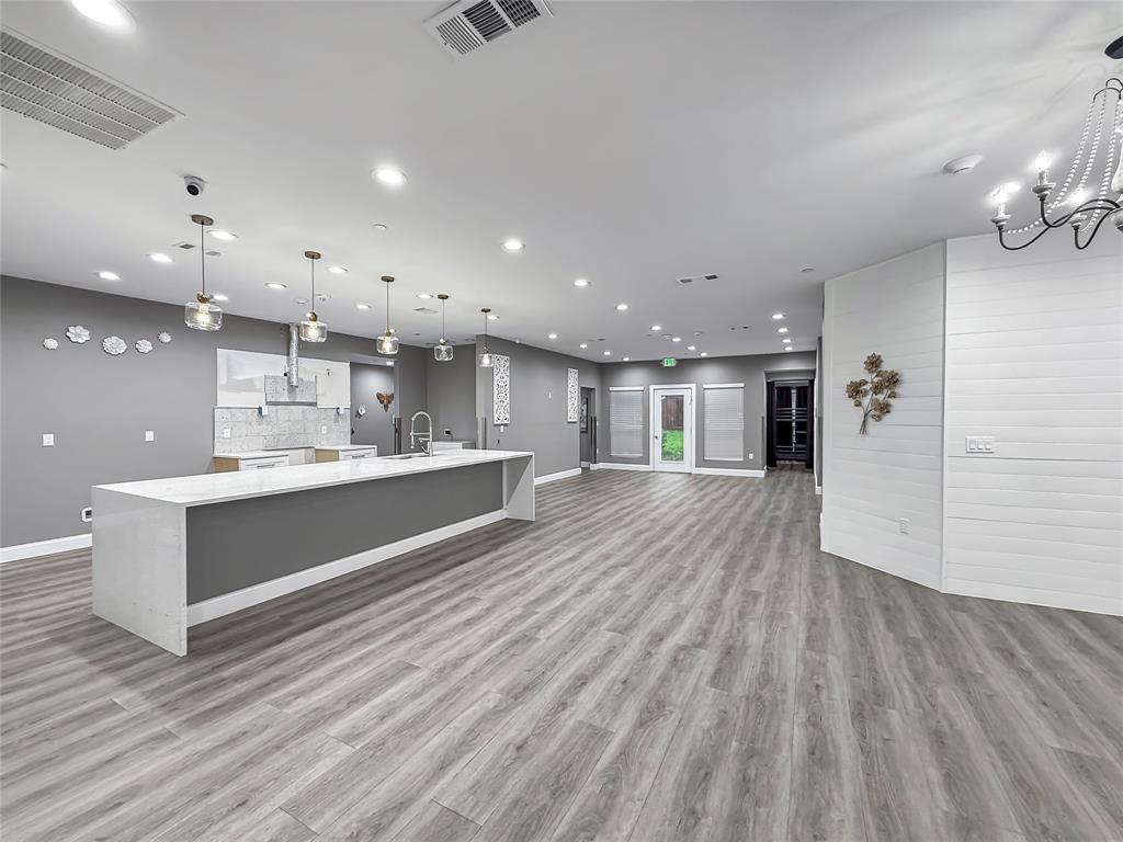 2402 Country Valley Road Garland, TX 75041 - Photo 12 of 39 a large white kitchen with a white countertops and cabinets