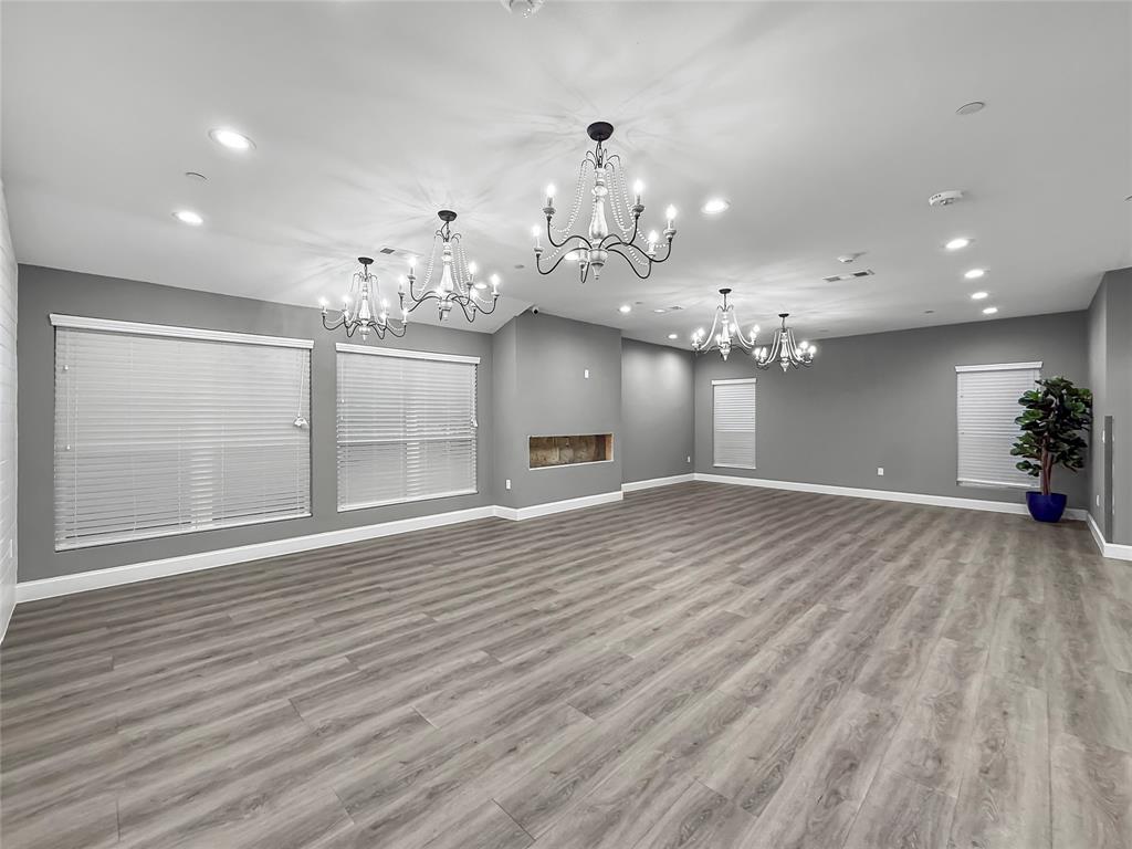 2402 Country Valley Road Garland, TX 75041 - Photo 15 of 39 a view of a room with chandelier and wooden floor
