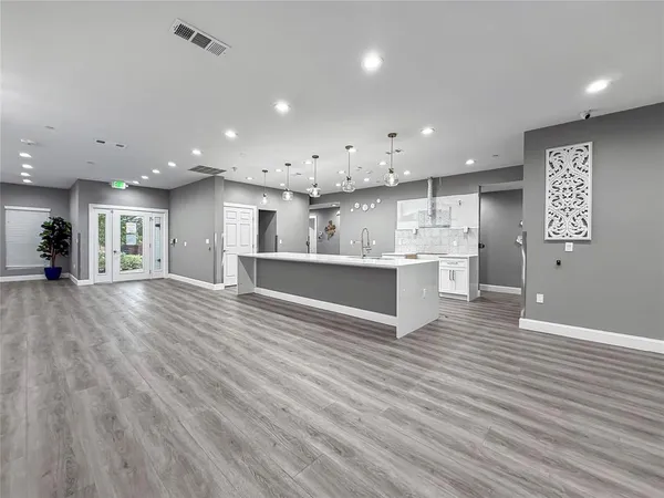 a view of kitchen with kitchen island and stainless steel appliances