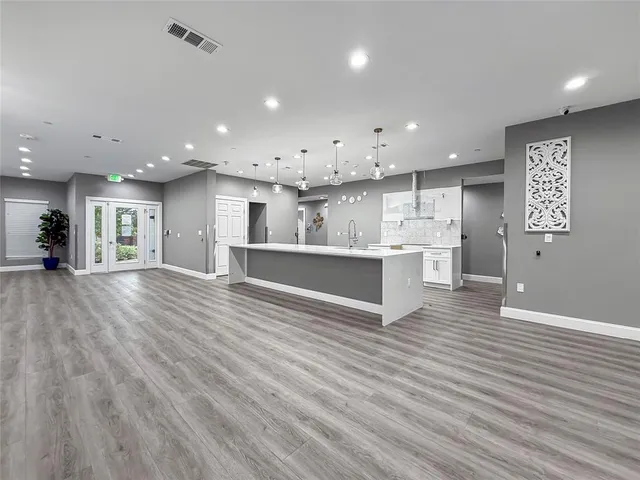 a view of kitchen with kitchen island and stainless steel appliances