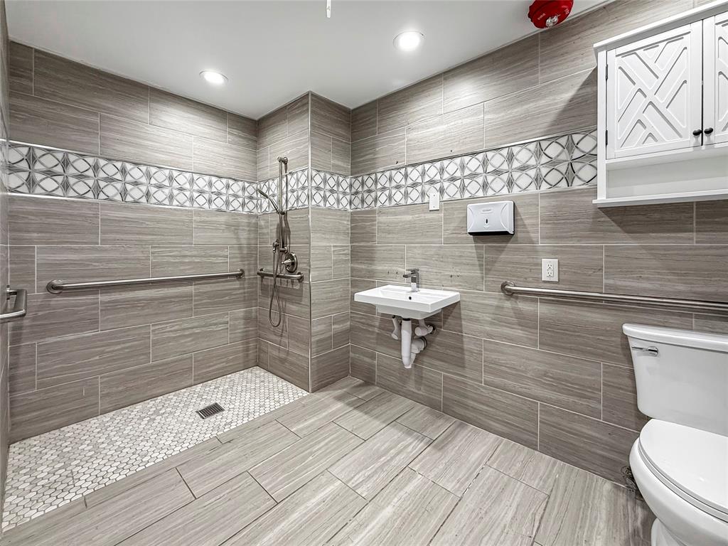 2402 Country Valley Road Garland, TX 75041 - Photo 17 of 39 a bathroom with a toilet and a shower