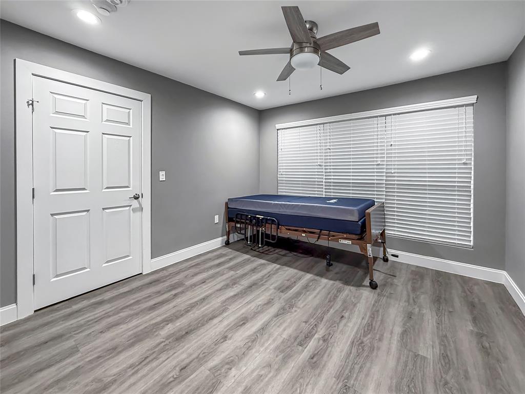 2402 Country Valley Road Garland, TX 75041 - Photo 21 of 39 a room with a table and wooden floor