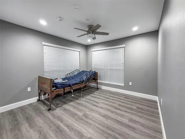 a room with wooden floor and a window