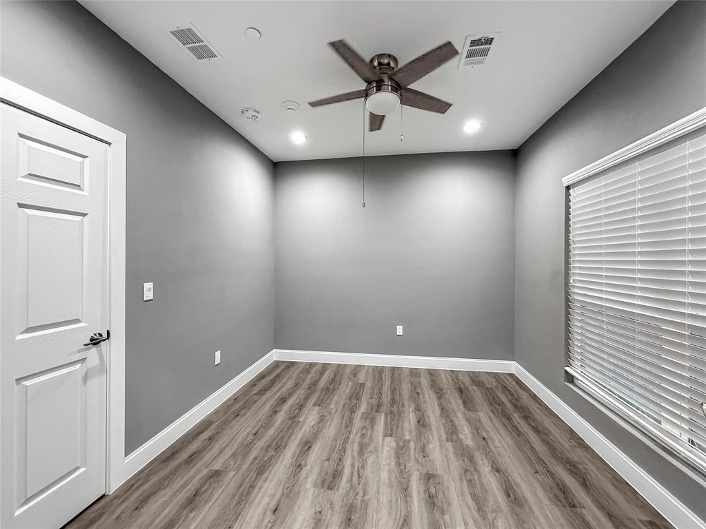 2402 Country Valley Road Garland, TX 75041 - Photo 29 of 39 wooden floor in an empty room with a window