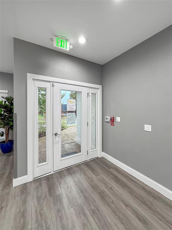 2402 Country Valley Road Garland, TX 75041 - Photo 32 of 39 wooden floor in an empty room with a window