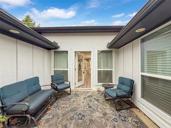 a outdoor living space with furniture and a rug