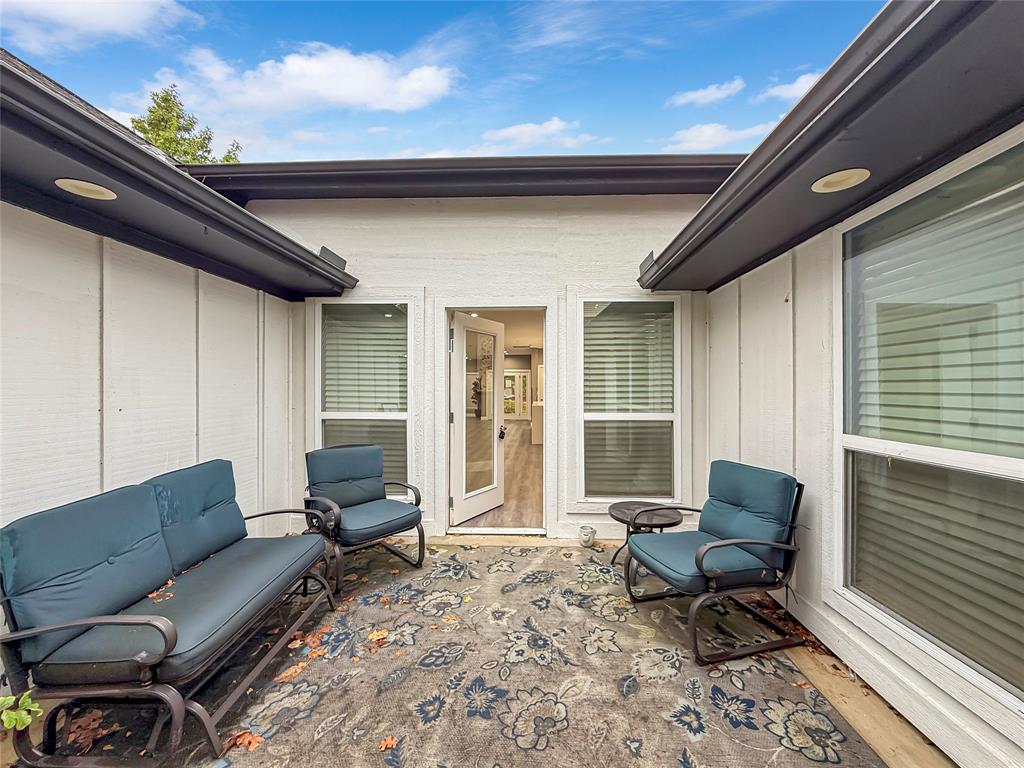 2402 Country Valley Road Garland, TX 75041 - Photo 35 of 39 a outdoor living space with furniture and a rug