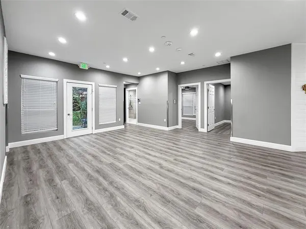 a view of empty room with wooden floor