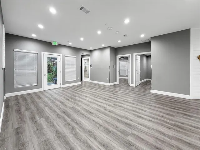 a view of empty room with wooden floor