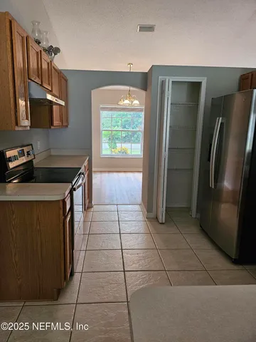 a kitchen filled with stainless steel appliances granite countertop a refrigerator and a stove