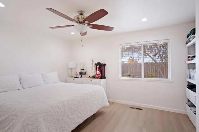 a bedroom with a large bed and a window