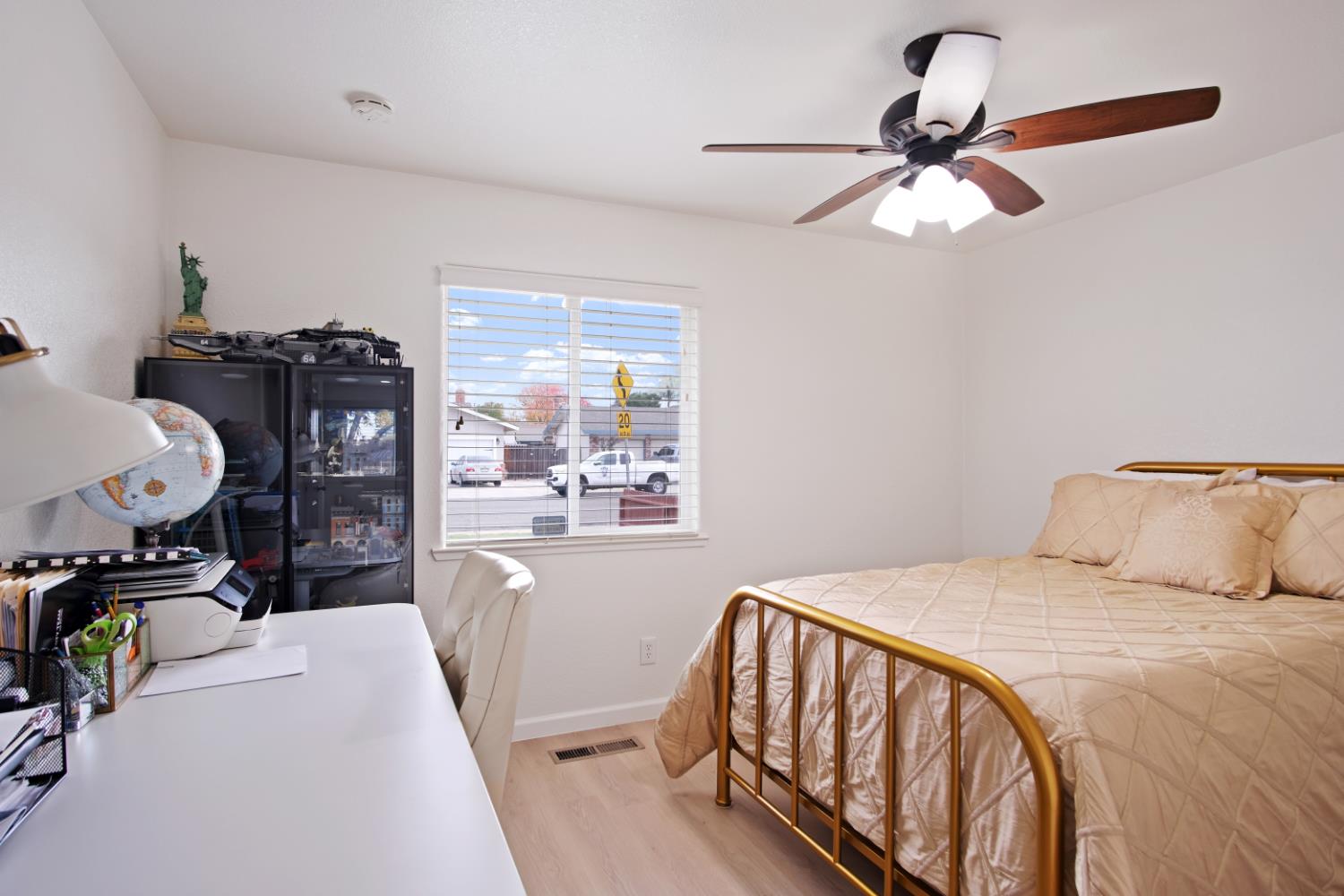 1921 Carleton Drive Turlock, CA 95382 - Photo 14 of 26 a bedroom with a bed and a chandelier