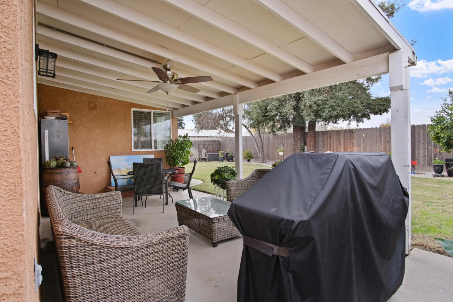 1921 Carleton Drive Turlock, CA 95382 - Photo 19 of 26 a view of patio with table and chairs potted plants and large tree