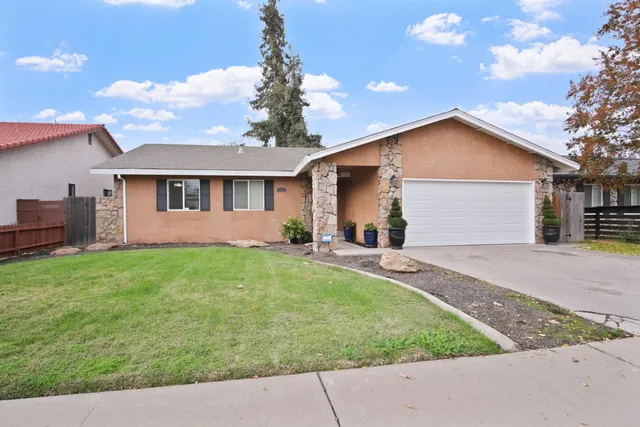 a front view of house with yard and outdoor seating