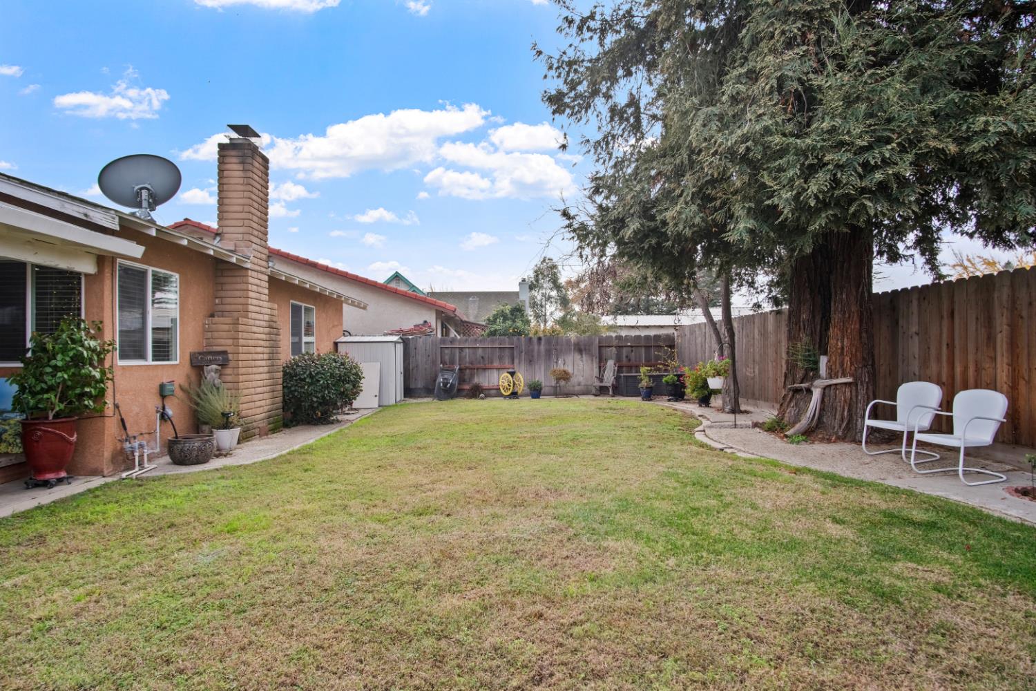 1921 Carleton Drive Turlock, CA 95382 - Photo 21 of 26 a view of a chair and table in backyard of the house