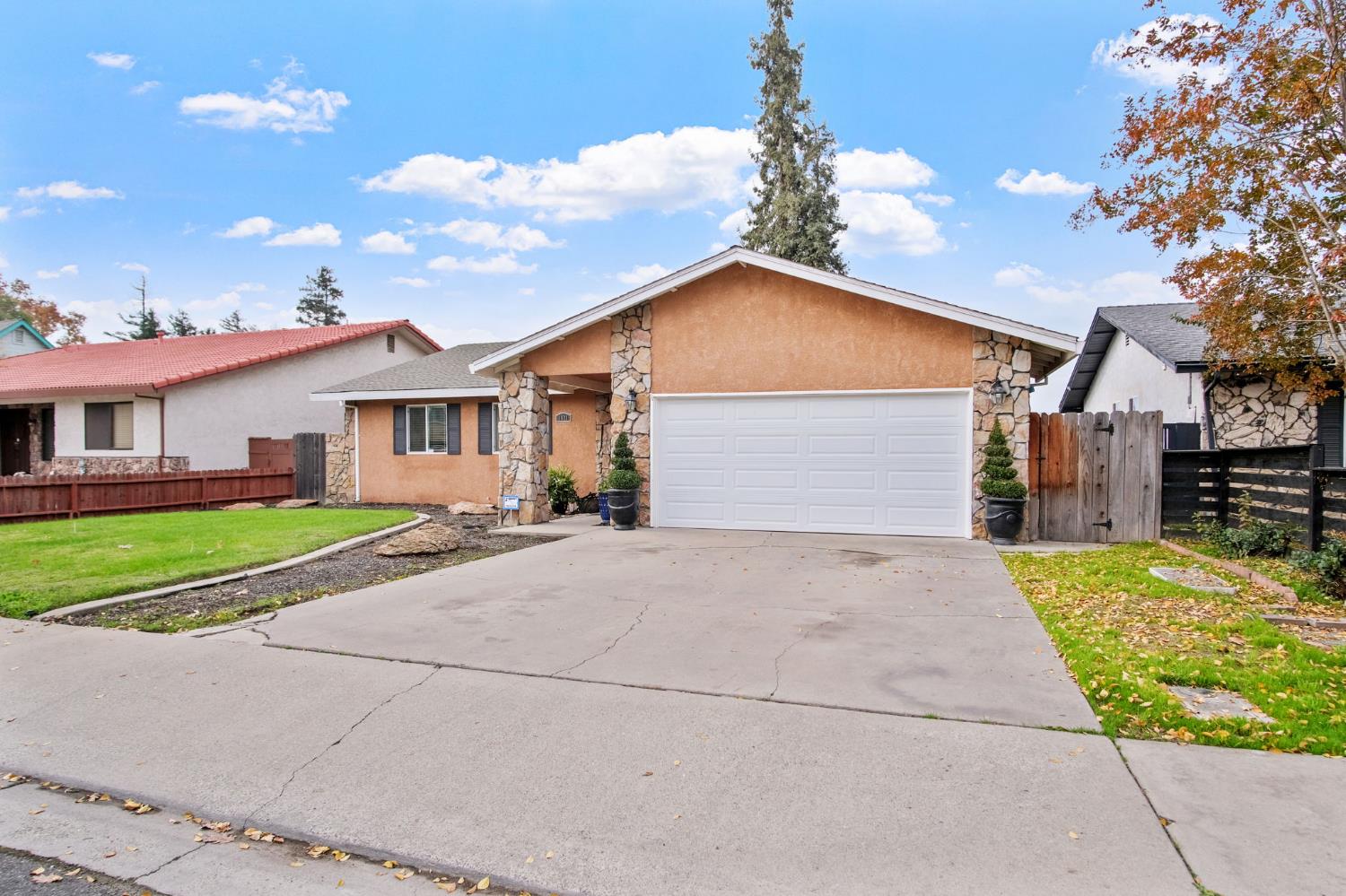1921 Carleton Drive Turlock, CA 95382 - Photo 3 of 26 a front view of a house with a yard and potted plants