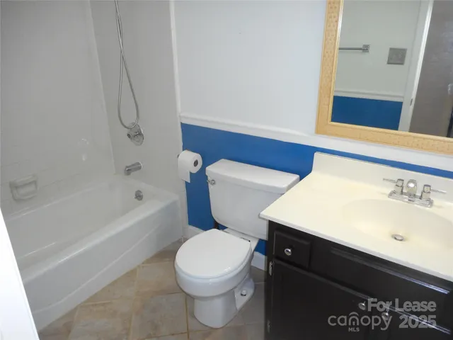 a bathroom with a sink a toilet and bathtub