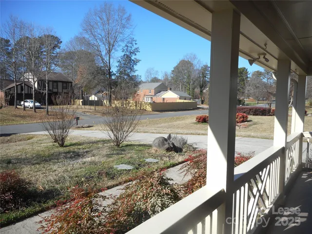 a view of a house with backyard from a balcony