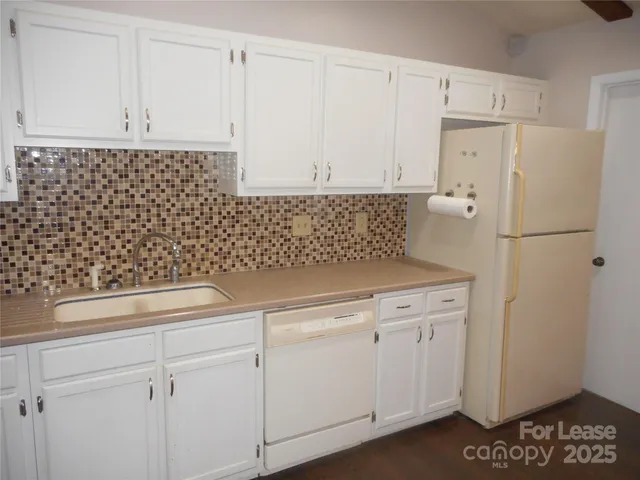 a kitchen with a sink and a refrigerator