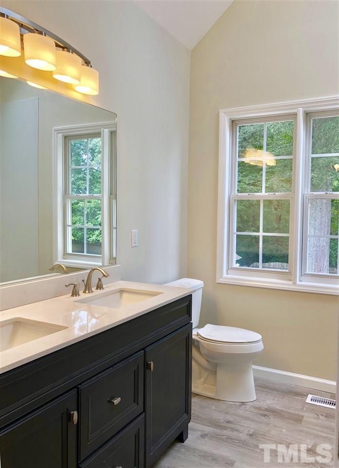 2825 Glastonbury Road Apex, NC 27539 - Photo 12 of 21 a bathroom with a sink and a large mirror