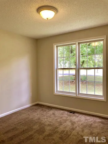 an empty room with a empty space and a window