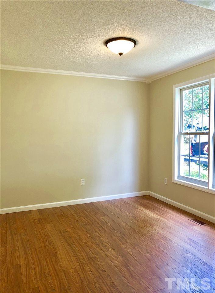 2825 Glastonbury Road Apex, NC 27539 - Photo 10 of 21 wooden floor in an empty room with a window