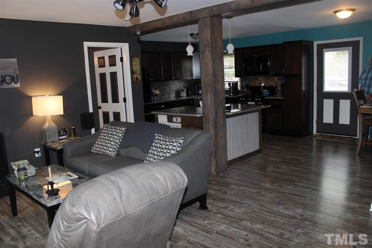 462 Pixley Pritchard Road Timberlake, NC 27583 - Photo 11 of 25 a large bedroom with a bed wooden floor and view kitchen