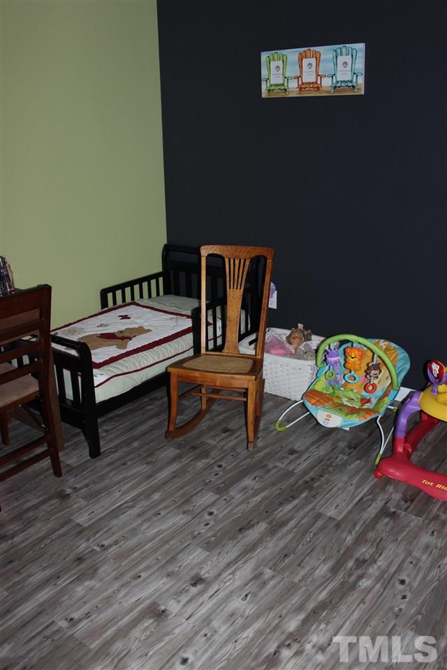 462 Pixley Pritchard Road Timberlake, NC 27583 - Photo 14 of 25 a reading room with furniture and wooden floor